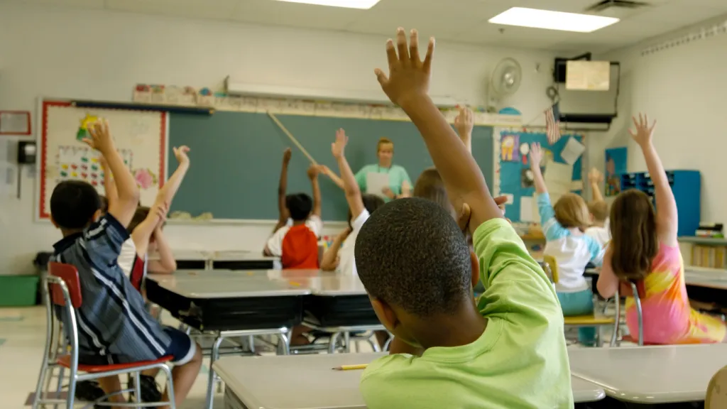 A classroom setting where students engage in financial literacy activities, showcasing practical approaches to financial education for youth.