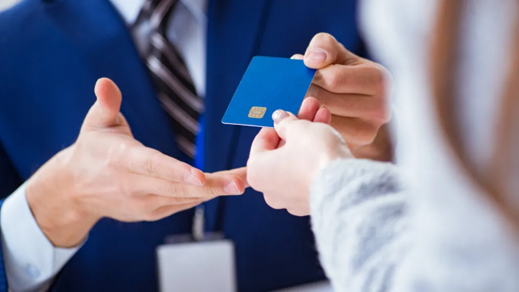 Man in a suit receiving a credit card