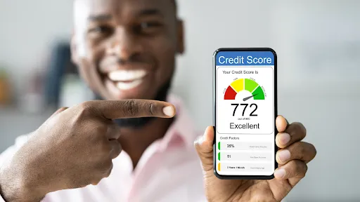 man pointing at his cell phone showing his credit score