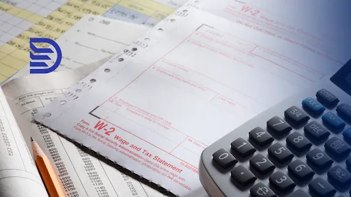 a calculator with papers on the table