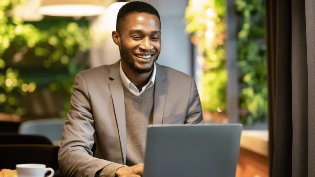 A South African investor using a laptop to research and buy ETFs, highlighting the ease of ETF investing.