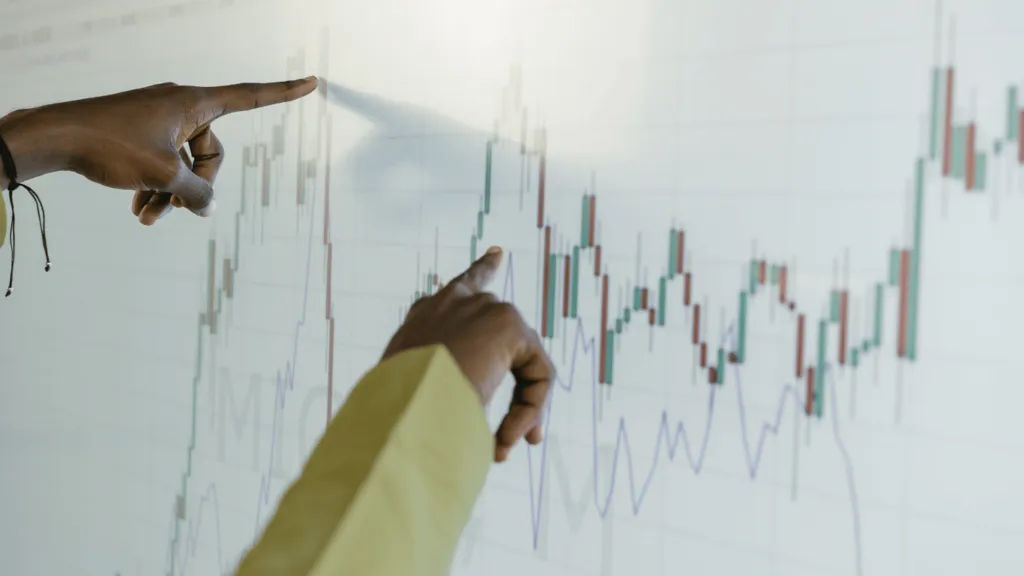 A financial expert presenting charts and data on a whiteboard, explaining the Impact of Global Market on investments.