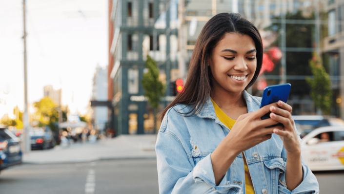 Young South African woman shopping online using her smartphone, symbolizing the digital shift from SA Credit Cards to BNPL platforms.